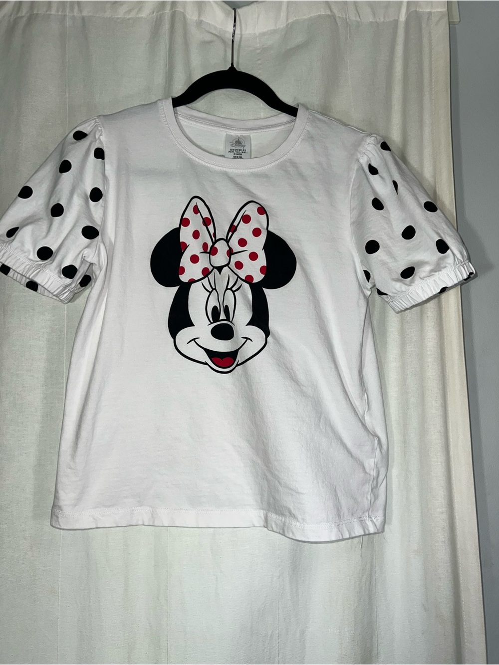 Used Disney White Minnie Mouse Tee with Red Polka Dot Bow a small  on the back .